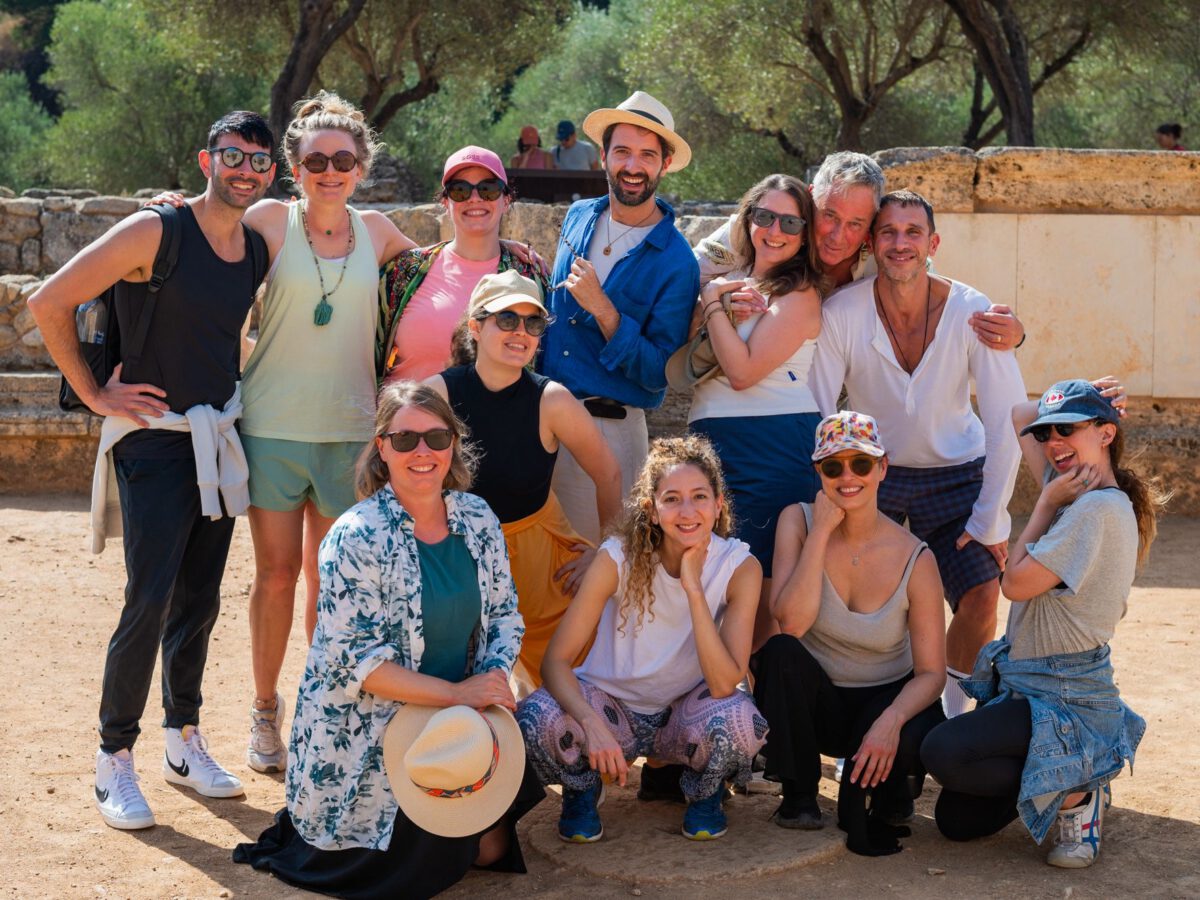 2025 Physical Lab retreat participants posing for a group photo at the ancient theatre of Aptera