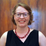 Headshot of Yvonne Maier, Physical Lab associate teaching artist, wearing a necklace and black dress