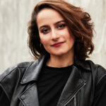 Headshot of Tatiana Spivakova, Physical Lab instructor, wearing a black t-shirt and leather jacket